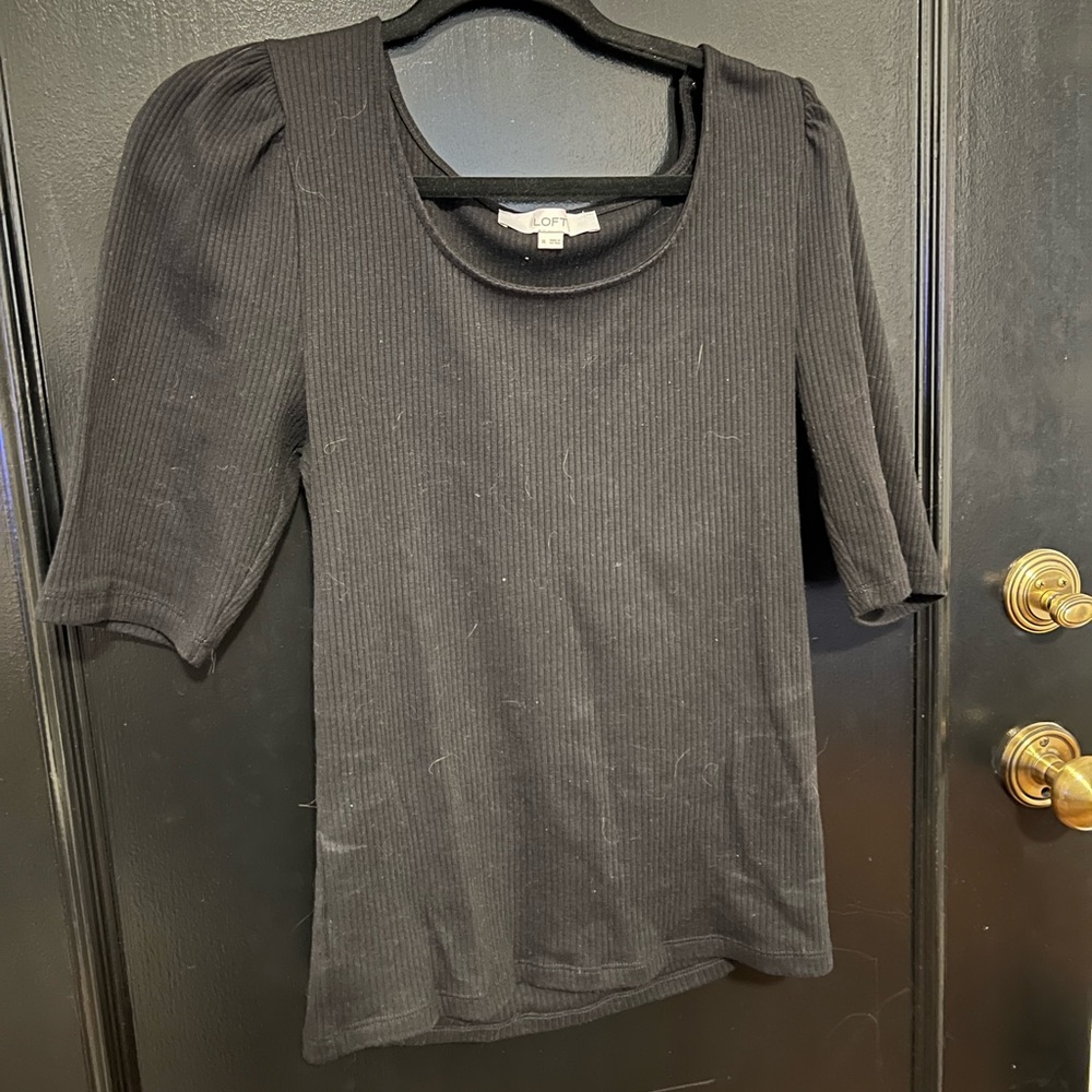 Black, ribbed scoop neck top with three quarter length sleeves.